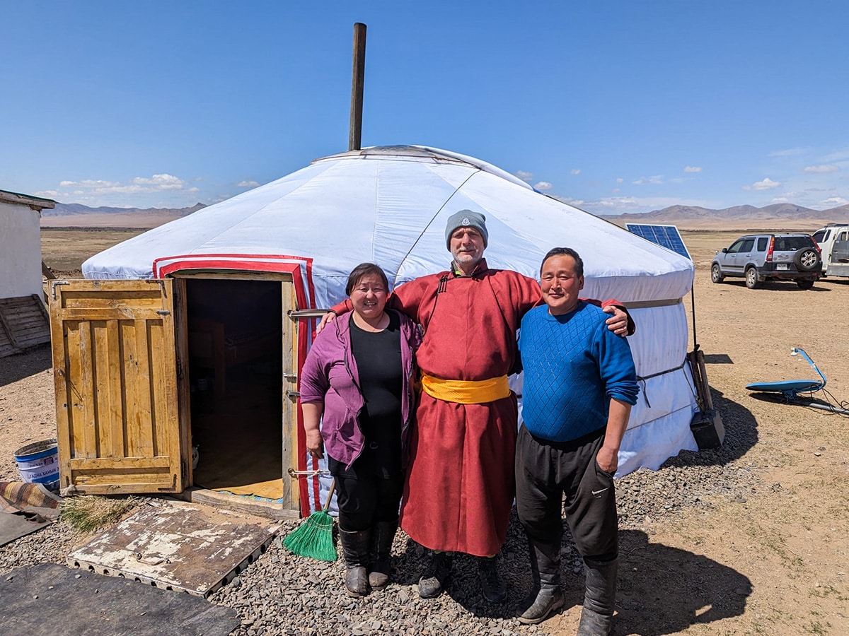 Participant standing with Host Family outside Nomad home in Mongolia